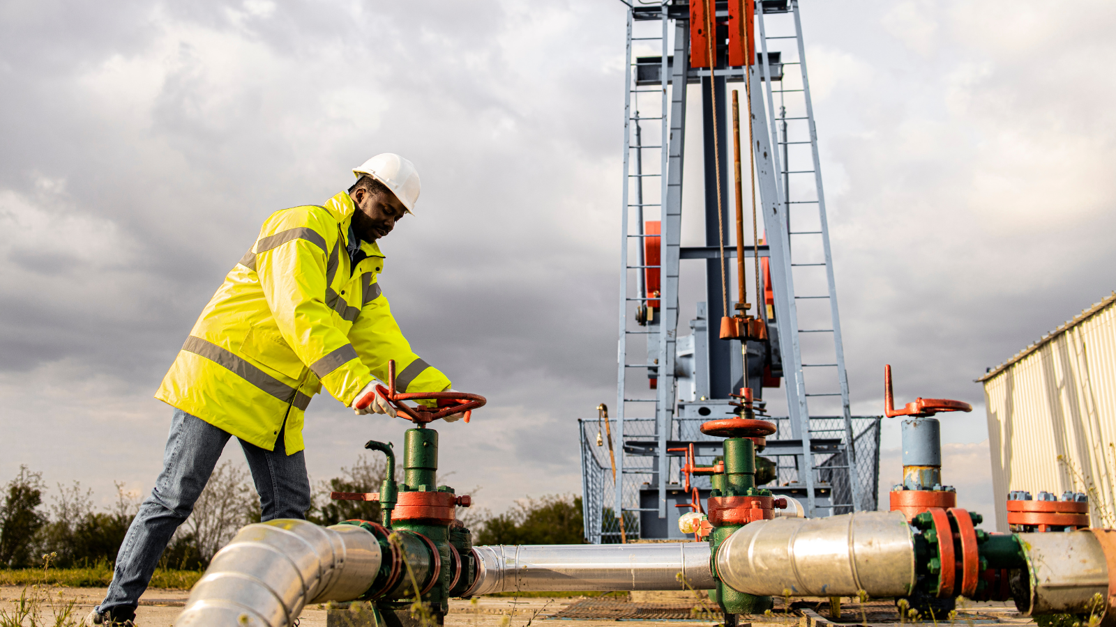 Image of a man closing industrial valve of an oil rig. Image used for the article: The Impact of Trump’s Presidency on the Oil and Gas Industry: Past, Present, and Future Outlook