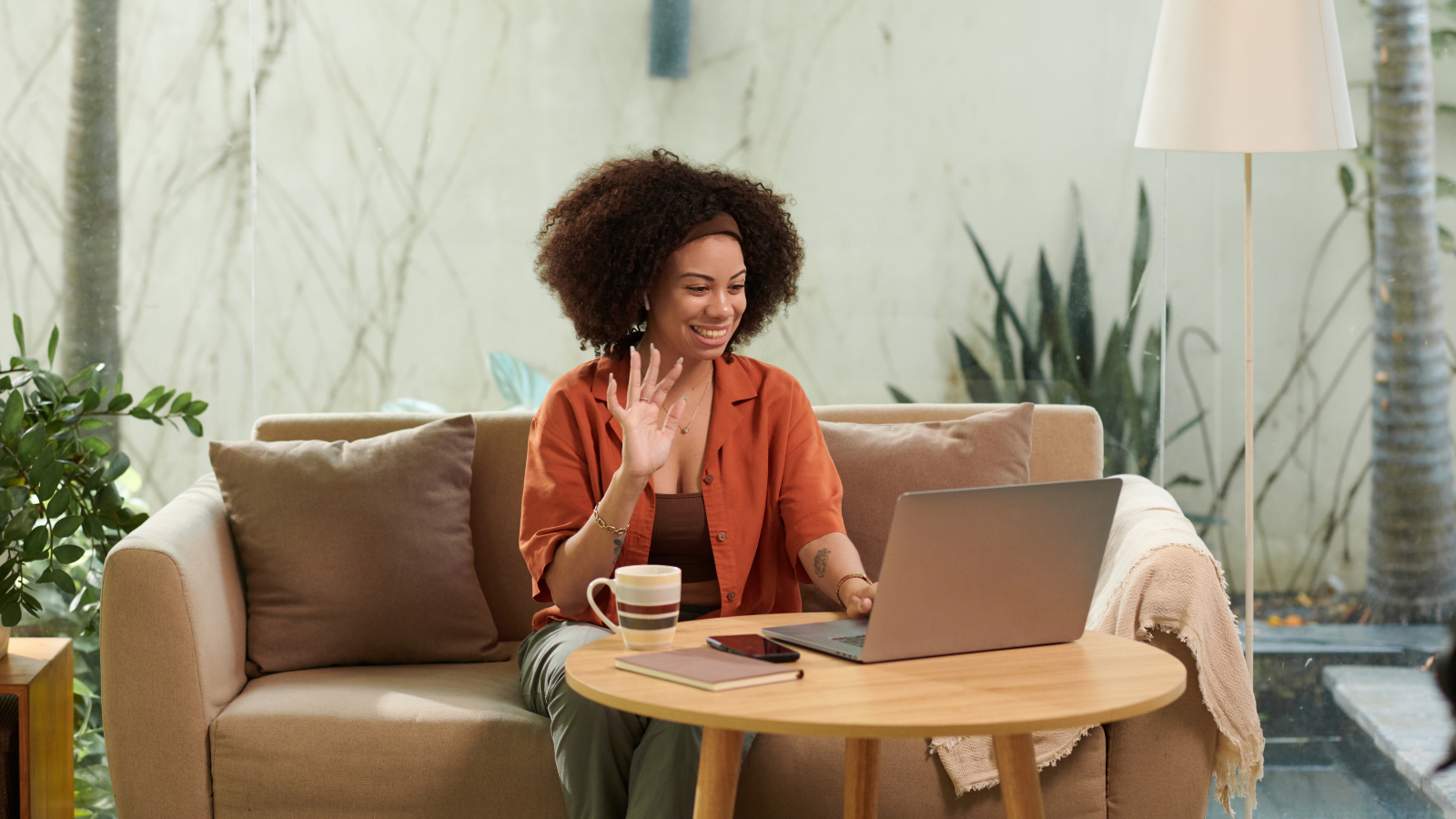 Image of a black woman on a video call on her laptop for Monarch's article: 6 Ways Savvy Hiring Managers Get Ahead This Summer